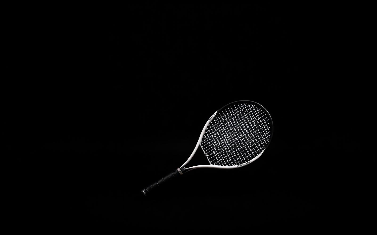 EVOX padel and tennis rackets on a black background